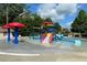 Gathering-friendly splash pad with colorful features and lounge chairs for relaxation at 7416 Capulin Crest Dr, Apex, NC 27539