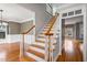 Traditional staircase with hardwood steps, white risers, and wood handrail at 7416 Capulin Crest Dr, Apex, NC 27539