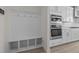 White kitchen with built-in bench seating and double ovens at 800 Summit Crest Ct, Apex, NC 27523