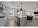 Modern kitchen with island, stainless steel appliances, and white cabinetry at 800 Summit Crest Ct, Apex, NC 27523