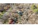 Aerial view of the house showing its location among tall trees and natural surroundings at 1014 Holden Rd, Youngsville, NC 27596