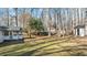 Expansive backyard featuring mature trees, a shed, and a fenced perimeter at 1014 Holden Rd, Youngsville, NC 27596