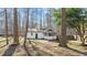 Quaint home featuring a charming screened-in porch surrounded by mature trees at 1014 Holden Rd, Youngsville, NC 27596