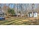 Large backyard with mature trees and a storage shed at 1014 Holden Rd, Youngsville, NC 27596