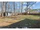 Spacious backyard featuring a shed, firepit, and tall wooden fence at 1014 Holden Rd, Youngsville, NC 27596