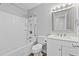 Bright bathroom features a shower-tub combo with a rainfall showerhead and a single sink vanity at 1014 Holden Rd, Youngsville, NC 27596