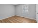 Neutral-toned bedroom with durable laminate flooring and a bright window for natural lighting at 1014 Holden Rd, Youngsville, NC 27596