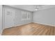 Freshly painted bedroom featuring laminate flooring and a new exterior door at 1014 Holden Rd, Youngsville, NC 27596