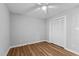 A comfortable bedroom featuring laminate floors, ceiling fan, and a closet for convenient storage at 1014 Holden Rd, Youngsville, NC 27596