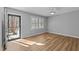 Bright bedroom with sleek laminate flooring and a modern ceiling fan at 1014 Holden Rd, Youngsville, NC 27596