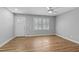 Spacious bedroom with modern ceiling fan and light-filled with exterior door at 1014 Holden Rd, Youngsville, NC 27596