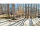 View of a long driveway leading up to a property surrounded by mature trees at 1014 Holden Rd, Youngsville, NC 27596