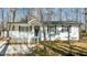 Charming home with white siding, black shutters, and a welcoming front porch and landscaped yard at 1014 Holden Rd, Youngsville, NC 27596