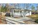 Well-maintained exterior with white siding, a charming porch, and a spacious driveway for easy parking at 1014 Holden Rd, Youngsville, NC 27596