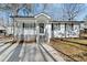 Beautifully renovated bungalow with white siding, a covered porch, and freshly manicured lawn at 1014 Holden Rd, Youngsville, NC 27596