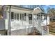 Detailed view of the front porch featuring white railings, black shutters, and a welcoming entrance at 1014 Holden Rd, Youngsville, NC 27596