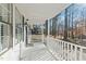 Welcoming front porch featuring white railings and black window shutters at 1014 Holden Rd, Youngsville, NC 27596