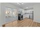 Bright kitchen with white cabinets, stainless steel appliances, and sliding doors to porch at 1014 Holden Rd, Youngsville, NC 27596