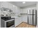 Updated kitchen features stainless steel appliances and modern backsplash at 1014 Holden Rd, Youngsville, NC 27596