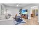 Cozy living room with neutral tones, wood floors, ceiling fan, and a view into the dining room at 1014 Holden Rd, Youngsville, NC 27596