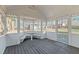 Screened-in porch with views of the backyard, features custom built-in seating and charming lattice details at 1014 Holden Rd, Youngsville, NC 27596