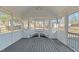 Covered screened porch perfect for outdoor dining and entertaining, with custom seating and views of the backyard at 1014 Holden Rd, Youngsville, NC 27596