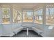 Cozy screened porch offering custom benches and a table, ideal for enjoying the outdoors in comfort at 1014 Holden Rd, Youngsville, NC 27596