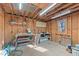 Interior of a wooden storage shed with workbench and natural lighting at 1014 Holden Rd, Youngsville, NC 27596