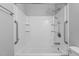 Clean shower with white tile, rainfall showerhead and handrails at 1014 Holden Rd, Youngsville, NC 27596