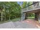 Backyard patio and deck with wooden stairs leading to a grassy area at 109 Aspenridge Dr, Holly Springs, NC 27540