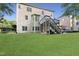 Spacious backyard with lush green grass and tiered deck with stairs at 109 Aspenridge Dr, Holly Springs, NC 27540