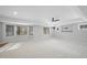 Large basement recreation room with bay windows and ceiling fan at 109 Aspenridge Dr, Holly Springs, NC 27540