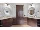 Dual vanities with dark wood cabinets and stylish mirrors at 109 Aspenridge Dr, Holly Springs, NC 27540
