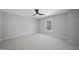 Spacious bedroom with window and ceiling fan at 109 Aspenridge Dr, Holly Springs, NC 27540