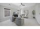 Spacious bonus room, featuring a ceiling fan and large windows at 109 Aspenridge Dr, Holly Springs, NC 27540