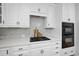 Kitchen with white cabinets, gas cooktop, and double oven at 109 Aspenridge Dr, Holly Springs, NC 27540