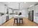 Modern kitchen with white cabinets, stainless steel appliances, and an island at 109 Aspenridge Dr, Holly Springs, NC 27540