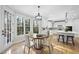 Bright kitchen with island, stainless steel appliances, and eat-in area at 109 Aspenridge Dr, Holly Springs, NC 27540