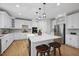 Bright kitchen with quartz countertops, stainless steel appliances, and sleek white cabinetry at 109 Aspenridge Dr, Holly Springs, NC 27540