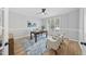 Bright home office with hardwood floors, natural light, a ceiling fan, and ample space for productivity at 109 Aspenridge Dr, Holly Springs, NC 27540