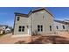 Back exterior of a two-story home featuring neutral toned siding and double hung windows at 1105 Opal Ln # 70, Durham, NC 27705
