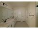 A bathroom featuring double sinks, large mirror, tile floors and a glass shower at 1105 Opal Ln # 70, Durham, NC 27705