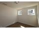 Bright bedroom featuring hardwood floors and natural light from two windows at 1105 Opal Ln # 70, Durham, NC 27705