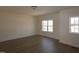 A bedroom featuring light-colored walls, hardwood floors and two double hung windows at 1105 Opal Ln # 70, Durham, NC 27705