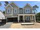 Newly constructed two-story home showcasing a covered entrance and attached two-car garage at 1105 Opal Ln # 70, Durham, NC 27705