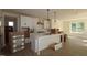 Bright, white kitchen with a center island, stainless steel appliances, and hardwood floors at 1105 Opal Ln # 70, Durham, NC 27705