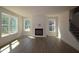 Bright living room featuring large windows, a fireplace, and beautiful hardwood floors at 1105 Opal Ln # 70, Durham, NC 27705