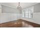 Bright dining room with hardwood floors, white wainscoting, and chandelier at 1205 Smith Creek Way, Wake Forest, NC 27587