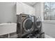 Laundry room with washer, dryer, cabinets, and utility sink at 1205 Smith Creek Way, Wake Forest, NC 27587