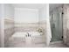 Spa-like bathroom with a soaking tub, shower, and modern finishes at 128 Bruce Dr, Cary, NC 27511